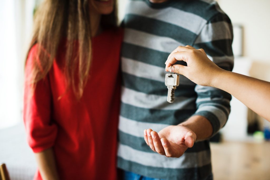 Couple receiving keys to new house